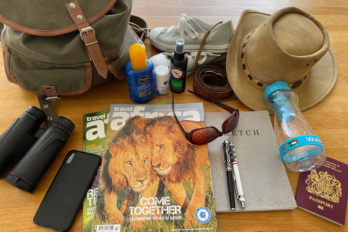 Best Gorilla Trekking Packing List 1 Backpack containing gorilla trekking essentials including water bottle, camera, rain jacket, and personal items