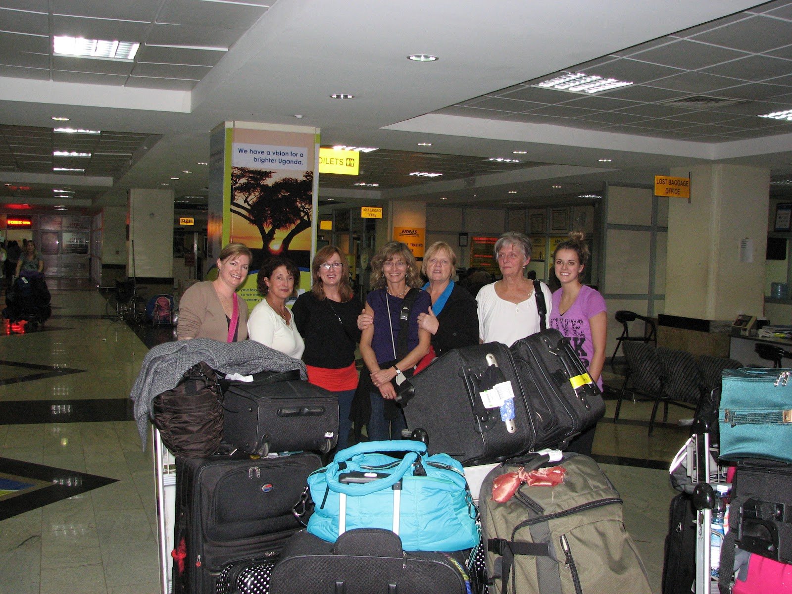 Uganda Safety Guide 13 Tourists standing together safely with luggage at Entebbe Airport
