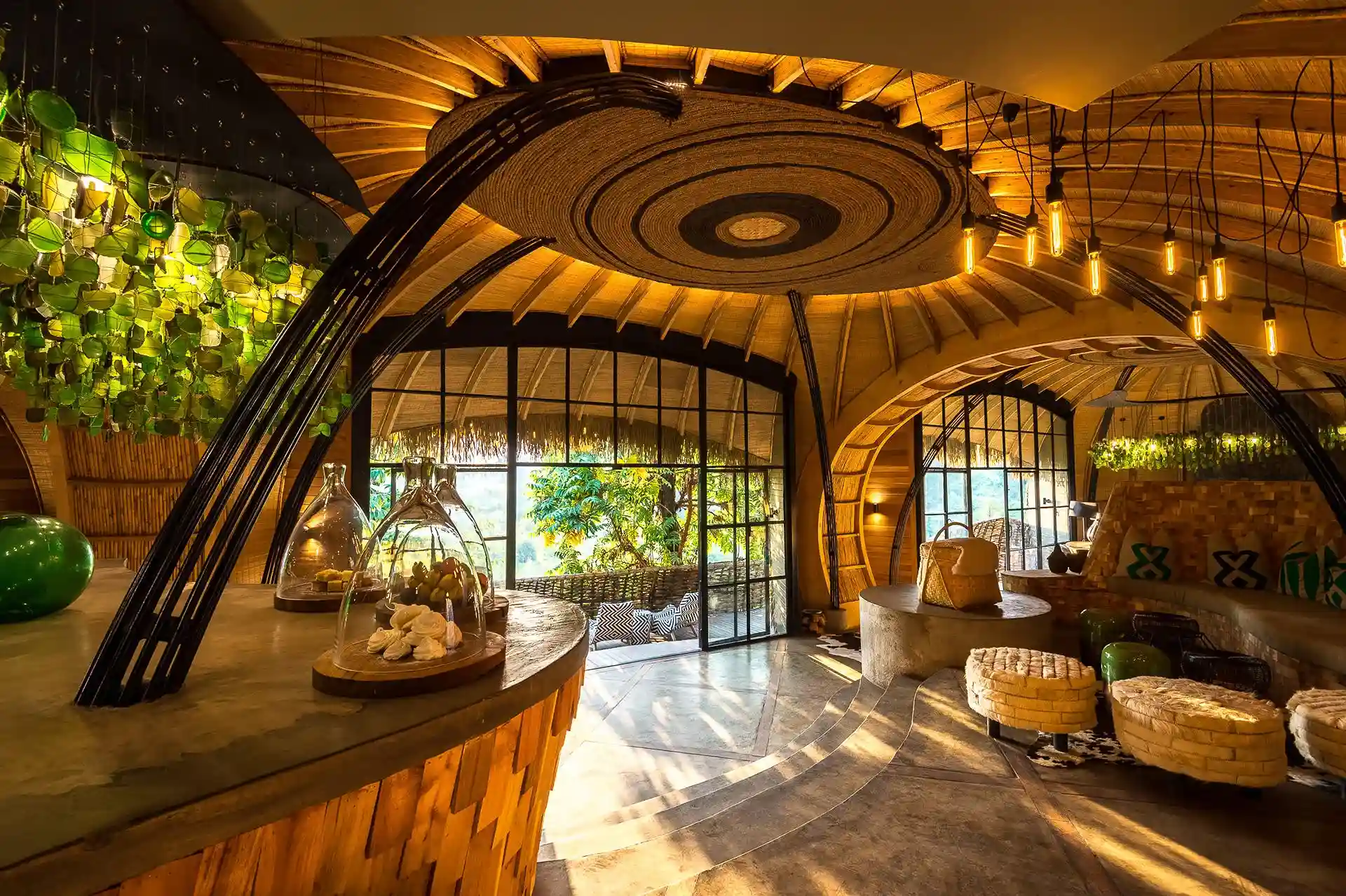 Eco-luxury lounge at Bisate Lodge Rwanda with curved wooden architecture.