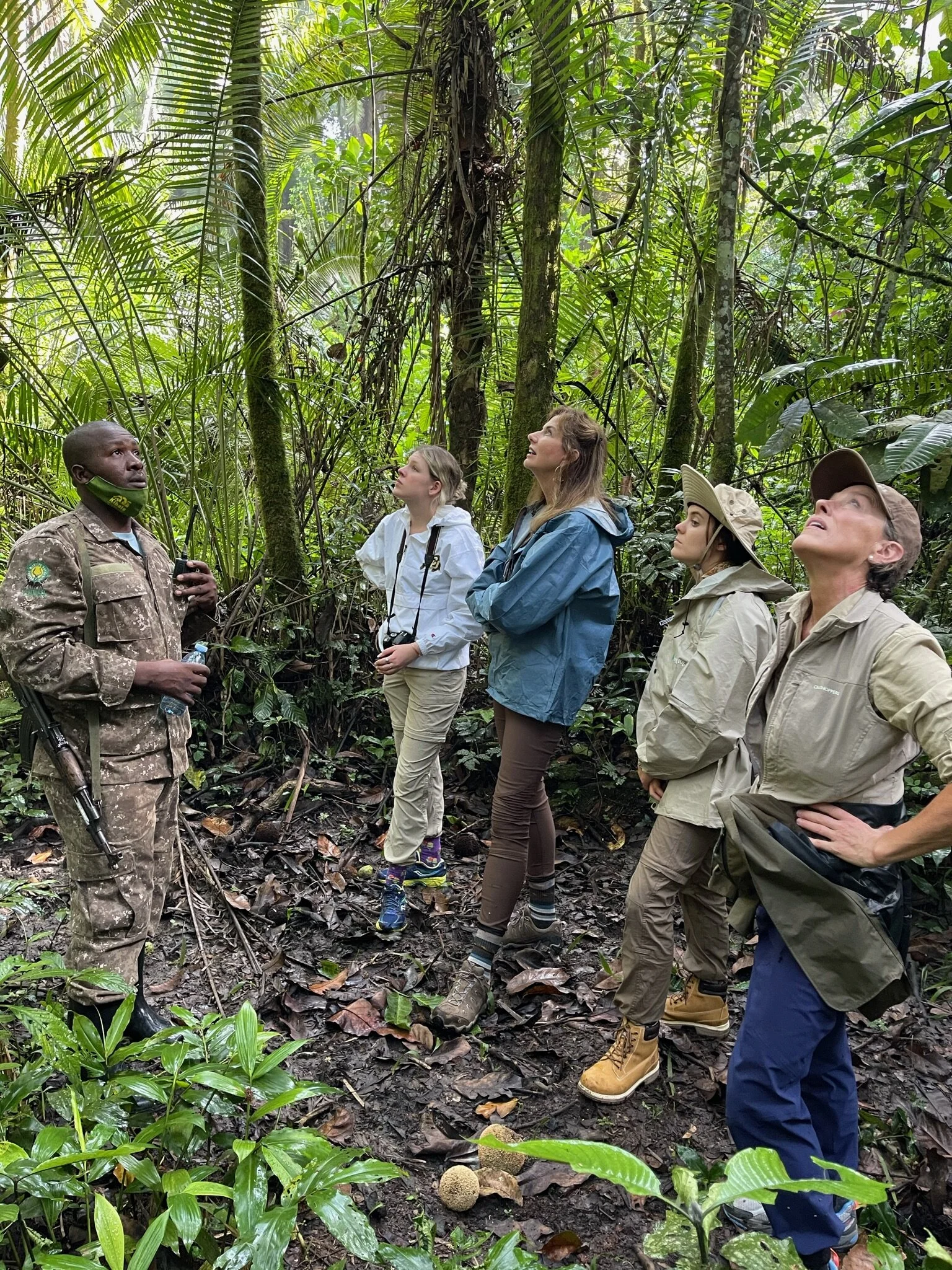 What to Pack for Kibale National Park 5 Chimpanzee trekkers wearing practical outdoor clothing with a guide in Kibale rainforest