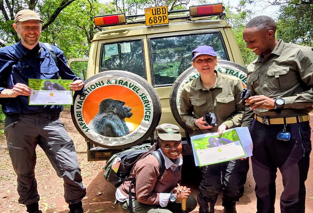 Rwanda vs Uganda Safari: Which Is Best? 2026/2027 13 Travelers holding gorilla trekking certificates beside a Safari Vacations and Travel Services Ltd safari vehicle during a Uganda and Rwanda gorilla safari