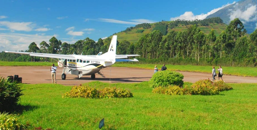 Ultimate Uganda Airport Guide: Best Travel Tips (2026/2027) 19 Safari aircraft at Kisoro Airfield with green hills and Virunga mountain scenery, serving Bwindi and Mgahinga gorilla trekking safaris in Uganda