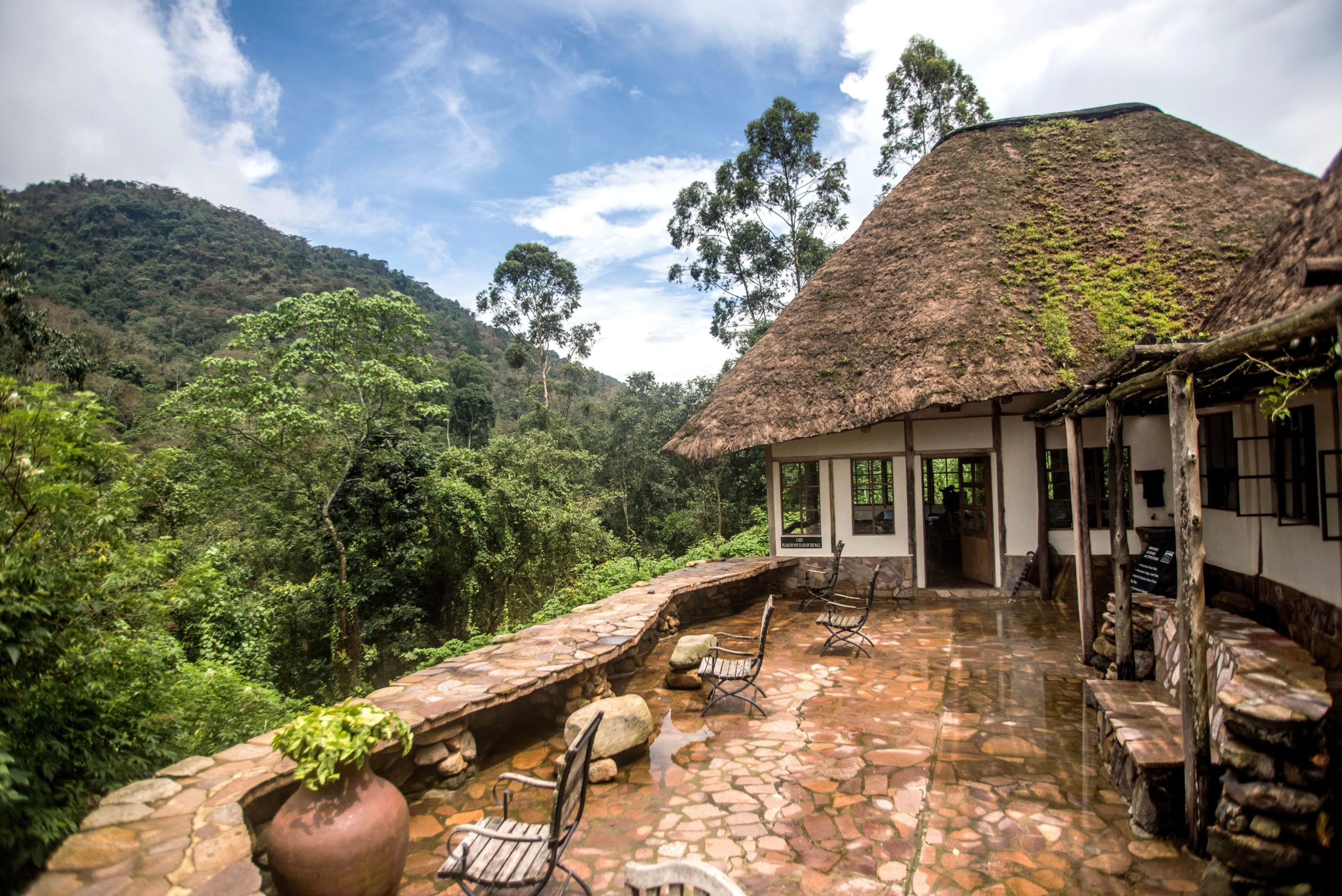 Nkuringo Gorilla Trekking Guide 17 A wooden luxury safari lodge balcony overlooking a misty valley and volcanoes