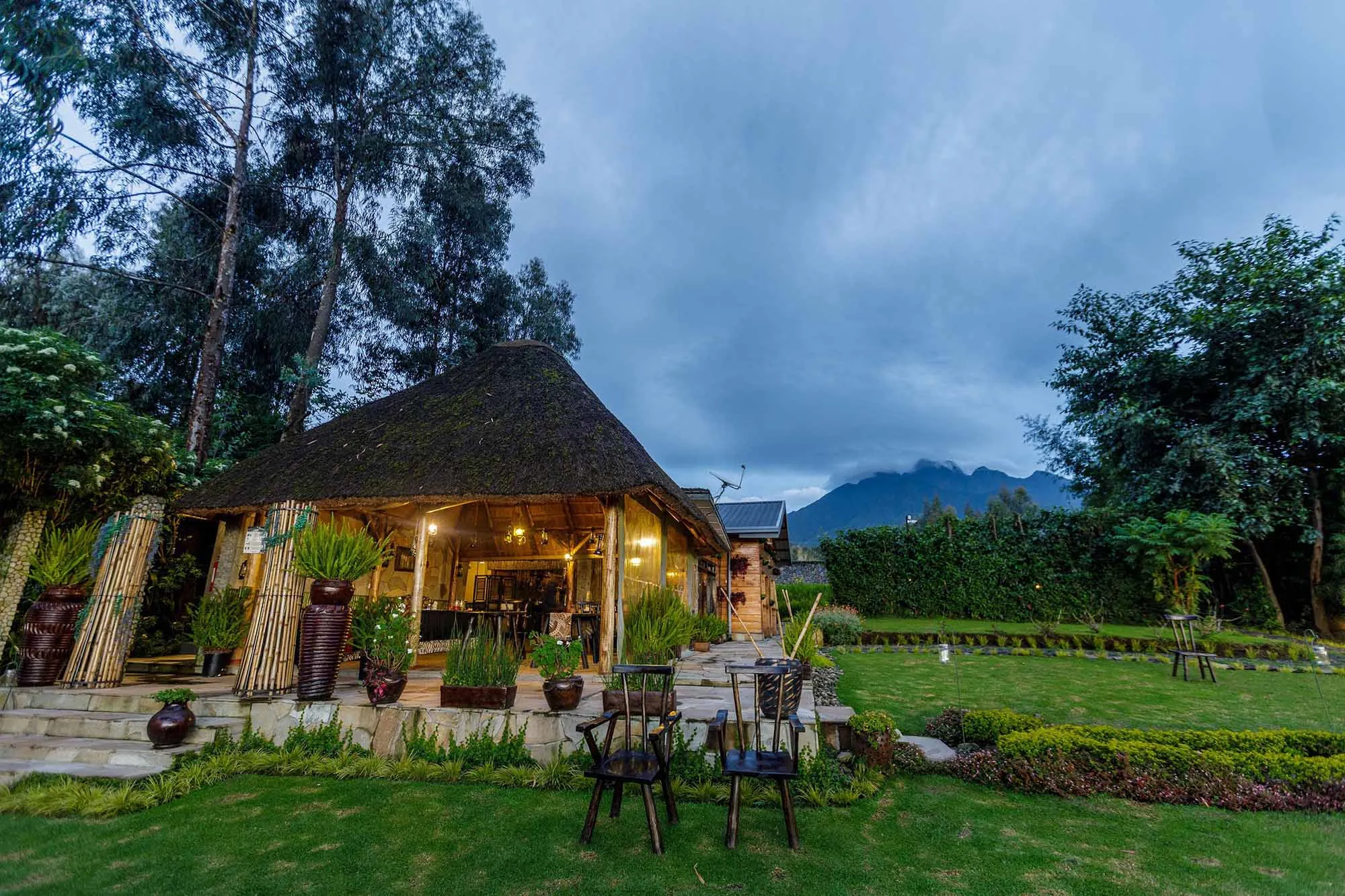 Best Rwanda Safari Packages in 2026/2027 | Wildlife Safari 13 Mid-range safari lodge near Volcanoes National Park in Rwanda with gardens, mountain views and traditional architecture.