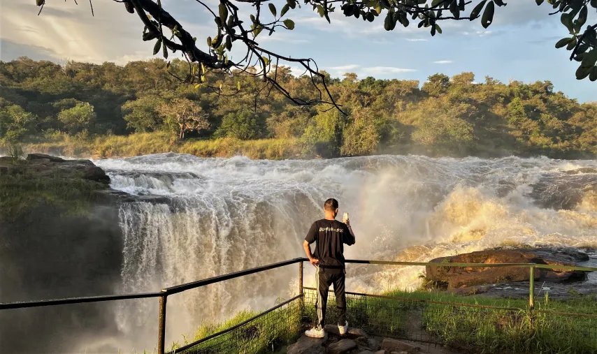 Rwanda vs Uganda Safari: Which Is Best? 2026/2027 19 Traveler overlooking the powerful Murchison Falls and Nile River inside Murchison Falls National Park in Uganda