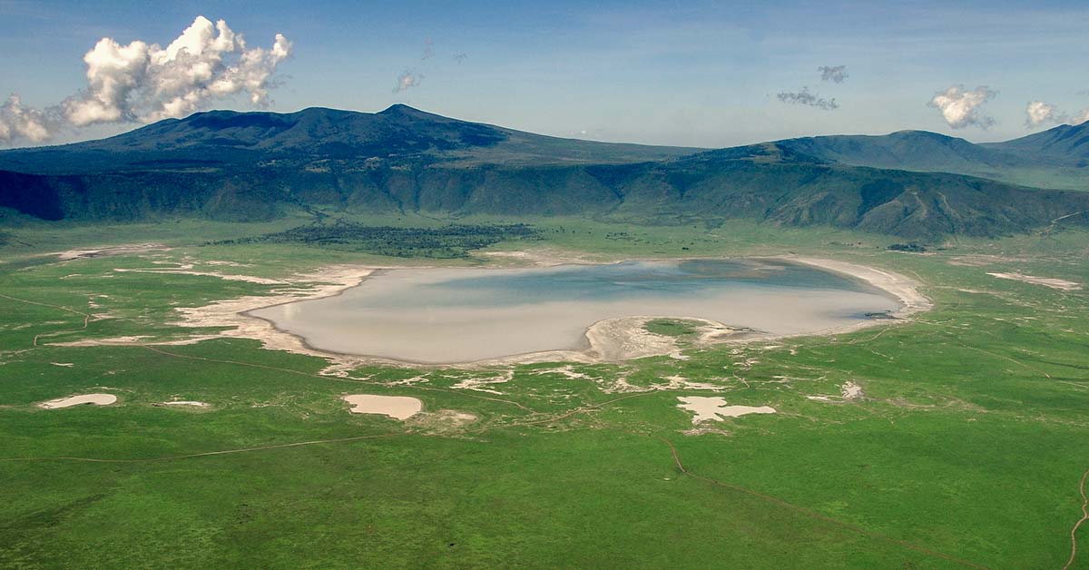East Africa Safari Guide: Cost, Best Time & Routes 2026/2027 27 Panoramic view across Ngorongoro Crater in Tanzania showing the vast caldera, grasslands and crater lake