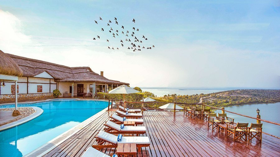 Best Uganda Luxury Holidays 2026/2027: Ultimate Safari Guide 33 Romantic luxury safari lodge with swimming pool, wooden deck and scenic water views, ideal for honeymoons and couples in Uganda