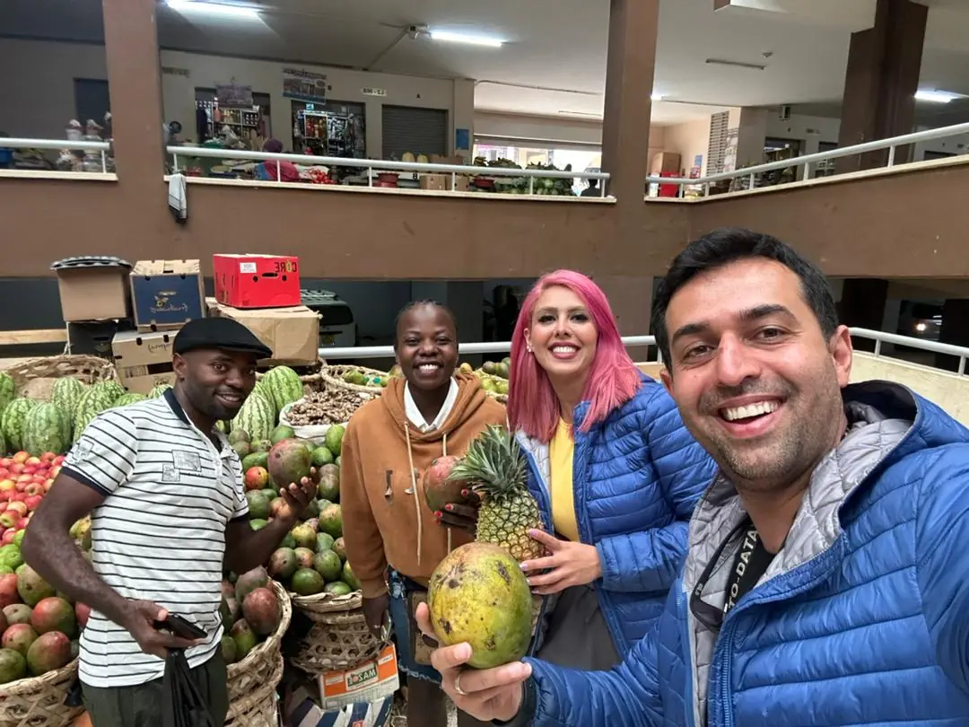 Complete Uganda Travel Tips: Best Safari Guide in 2026/2027 25 International travelers visiting a local fruit market during a Uganda safari