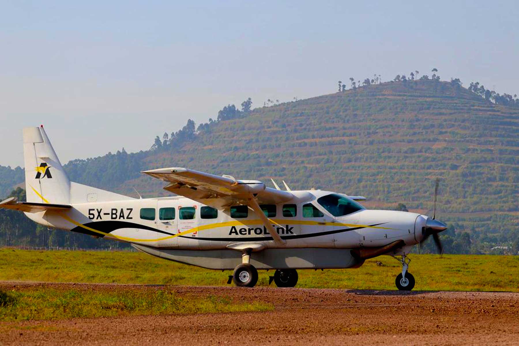 Best Uganda Luxury Holidays 2026/2027: Ultimate Safari Guide 37 AeroLink light aircraft on an airstrip in Uganda, representing comfortable and convenient fly-in safari transfers between national parks