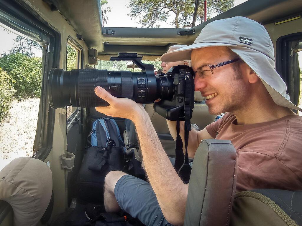 Uganda Safari Tips 1 Wildlife photographer using a professional camera during a Uganda Safari