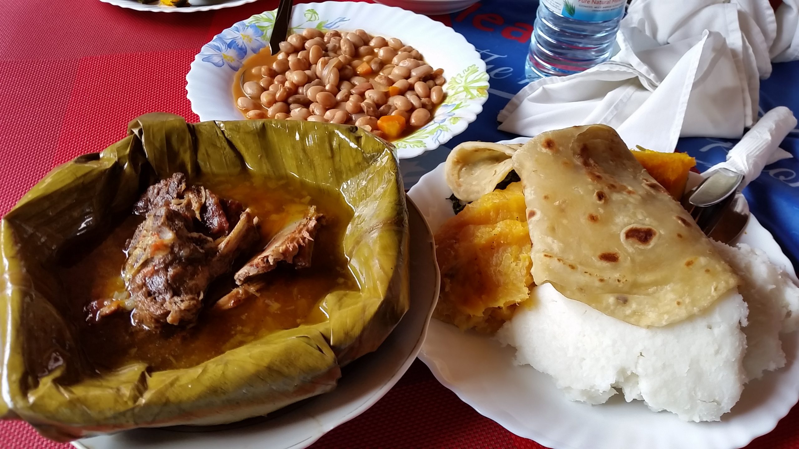 Uganda Culture Guide 31 A Ugandan feast with beef luwombo, mashed matooke, posho, chapati, and beans.