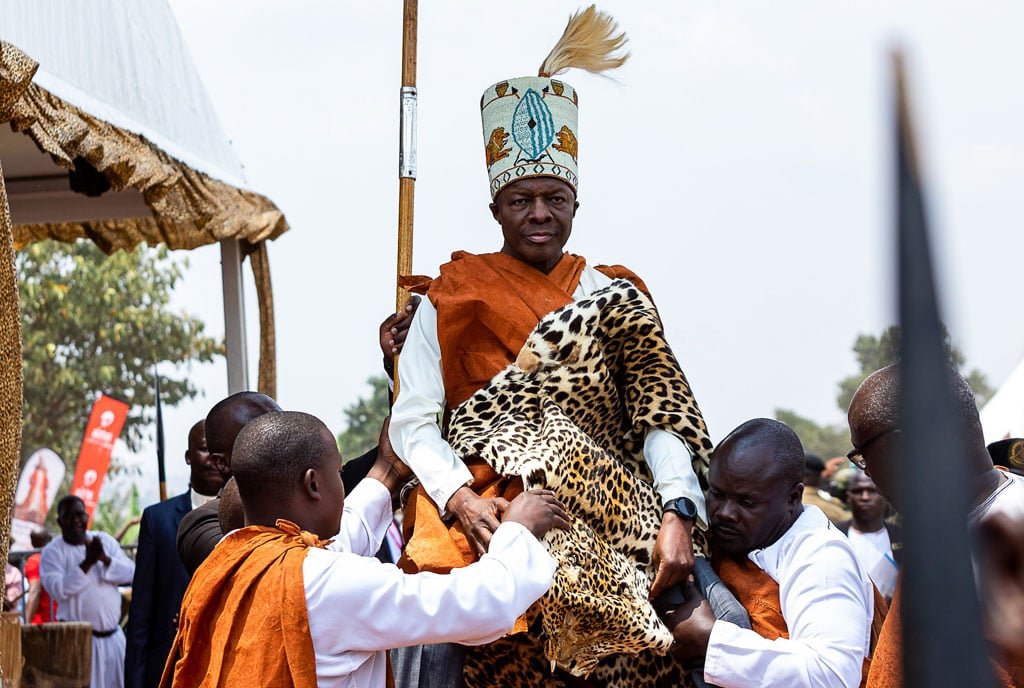 Uganda Culture Guide 5 Kabaka of Buganda carried on shoulders wearing traditional robes and leopard skin.
