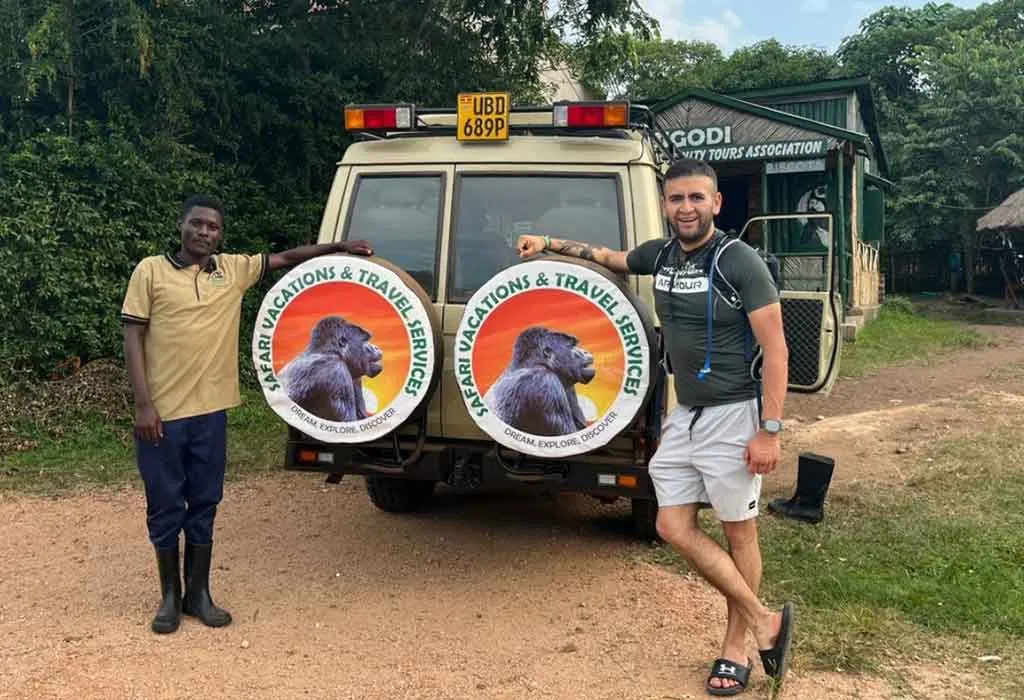 7 Day Uganda Safari: Best Wildlife Safari Tour 2026/2027 15 Safari Vacations and Travel Services guest with guide and 4x4 safari vehicle at Bigodi Wetland Sanctuary near Kibale National Park, Uganda