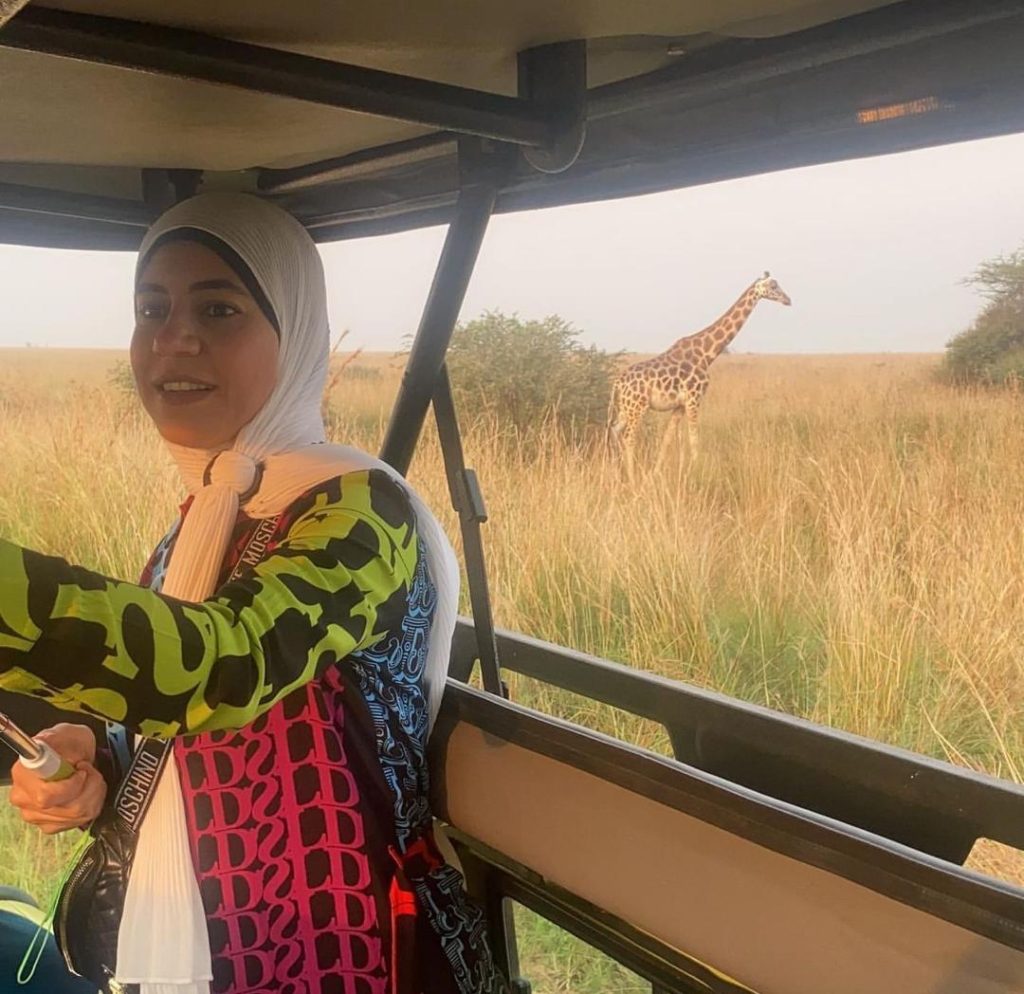 Muslim woman wearing a hijab enjoying a private wildlife game drive during a Halal Uganda Safari from Malaysia